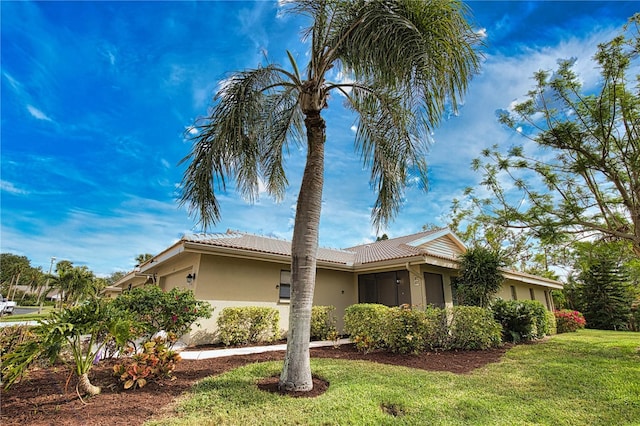 view of side of home featuring a yard