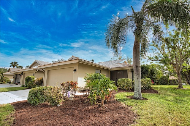 ranch-style house featuring a front lawn and a garage