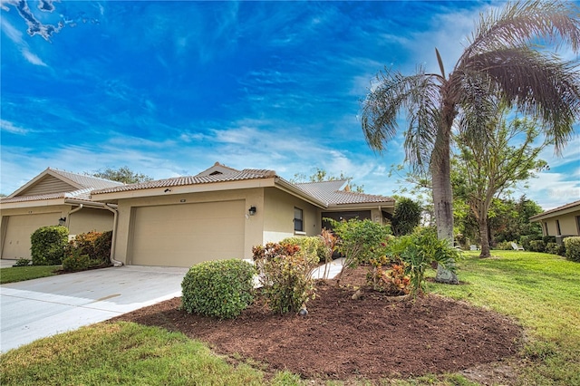 view of front of house with a garage and a front lawn