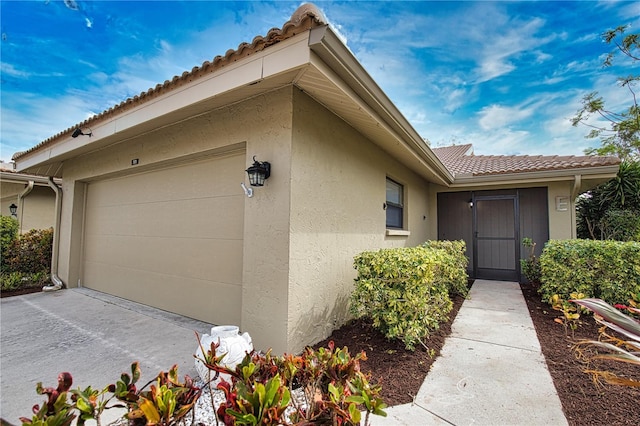 view of exterior entry featuring a garage