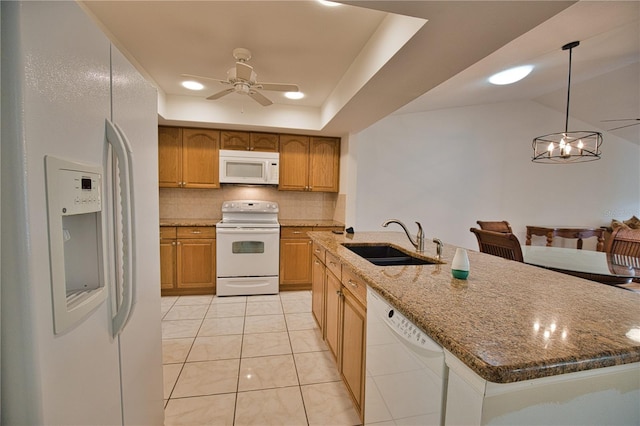 kitchen featuring white appliances, sink, light tile patterned floors, decorative light fixtures, and a kitchen island