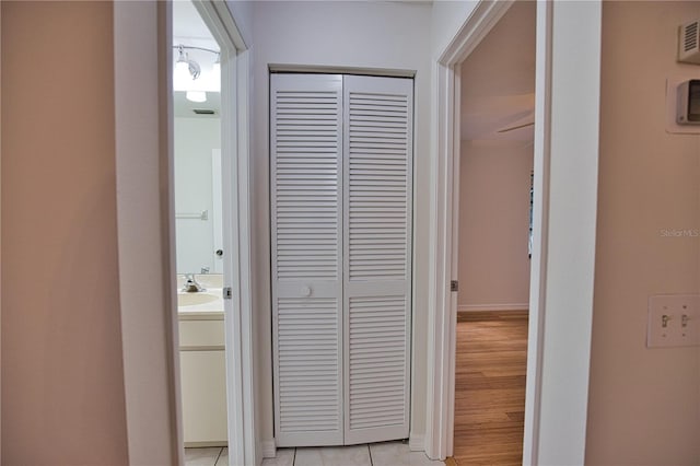 hall featuring light hardwood / wood-style flooring and sink