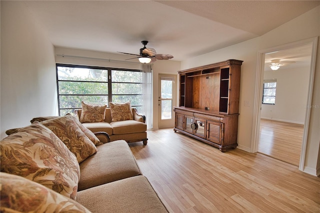 living room featuring light wood-type flooring, vaulted ceiling, and ceiling fan