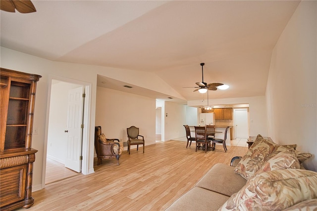 living room with light wood-type flooring, vaulted ceiling, and ceiling fan