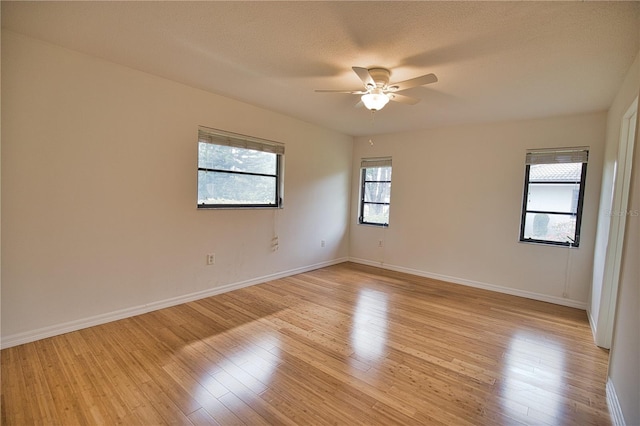 spare room featuring ceiling fan, a textured ceiling, and light hardwood / wood-style flooring