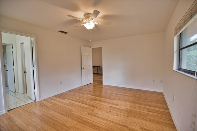 empty room featuring ceiling fan and light hardwood / wood-style flooring