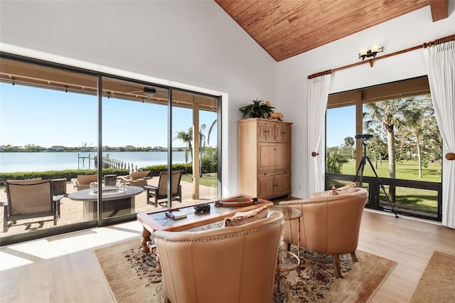 sunroom / solarium with a water view, wooden ceiling, a wealth of natural light, and vaulted ceiling