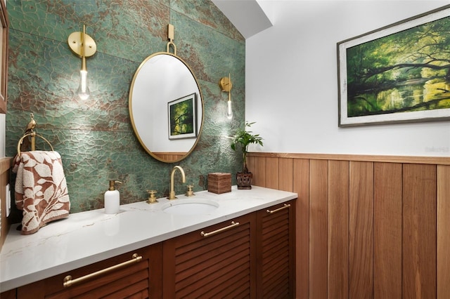 bathroom with wood walls and vanity