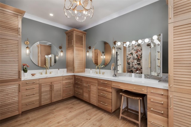 bathroom with hardwood / wood-style floors, vanity, crown molding, and a chandelier