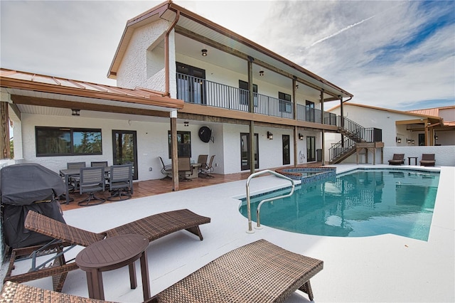 view of swimming pool with a grill, an in ground hot tub, and a patio