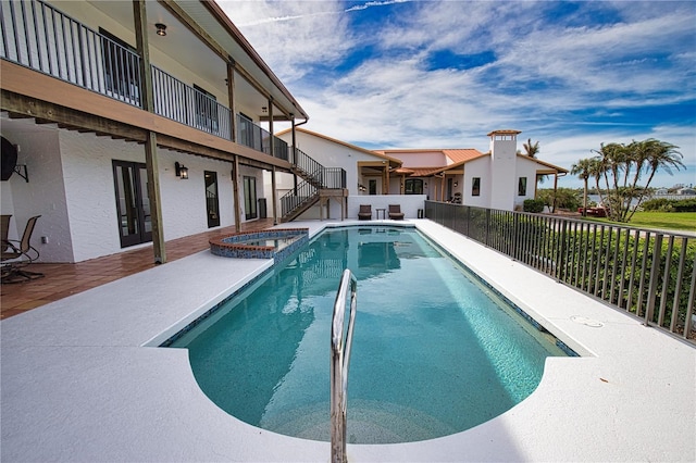 view of swimming pool featuring an in ground hot tub