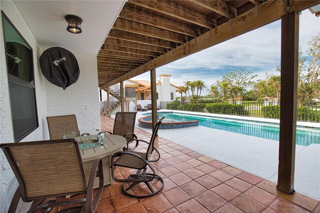 view of swimming pool with an in ground hot tub and a patio