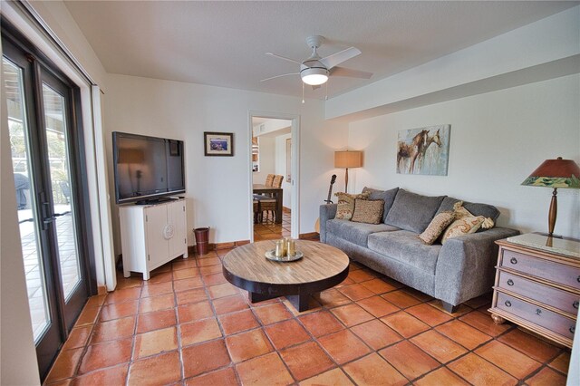 living room featuring ceiling fan, light tile patterned floors, and french doors