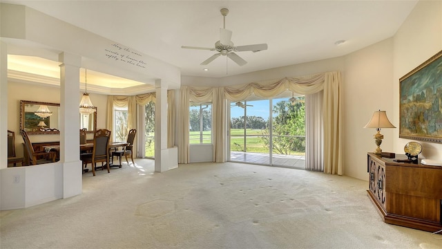 interior space featuring carpet floors, a tray ceiling, and ceiling fan