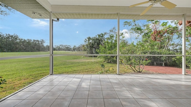 unfurnished sunroom featuring ceiling fan