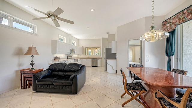 living room featuring light tile patterned floors and ceiling fan with notable chandelier