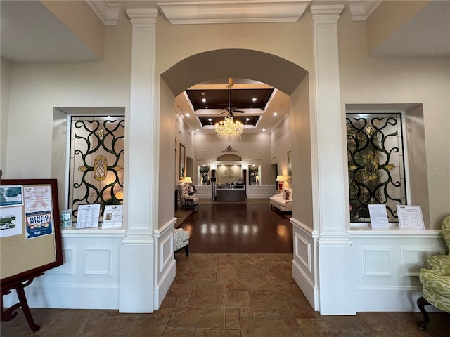 6713 Stone River Rd Unit 205, Bradenton, FL 34203 - hall featuring decorative columns, crown molding, a chandelier, dark stone finish floors, and arched walkways