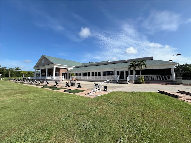 6713 Stone River Rd Unit 205, Bradenton, FL 34203 - back of property featuring a patio and a lawn