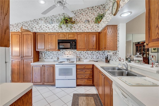 kitchen featuring ceiling fan, sink, lofted ceiling, white appliances, and light tile patterned floors