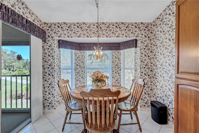 dining area with light tile patterned floors and an inviting chandelier