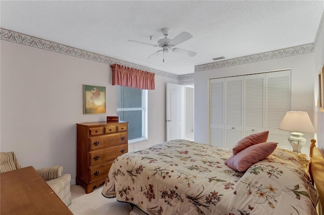 bedroom with light carpet, a textured ceiling, a closet, and ceiling fan