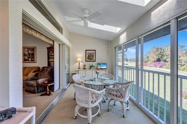 sunroom with lofted ceiling with skylight and ceiling fan