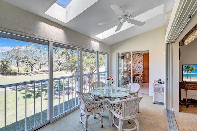 sunroom / solarium with ceiling fan and lofted ceiling with skylight