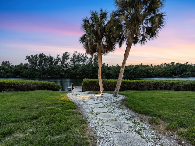 yard at dusk with a water view