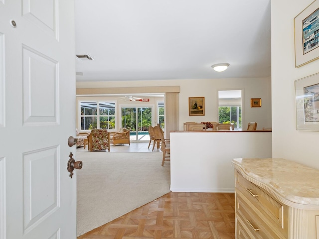 kitchen with light brown cabinets and light parquet flooring