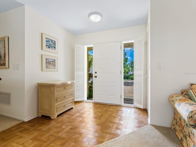 entryway with light parquet flooring