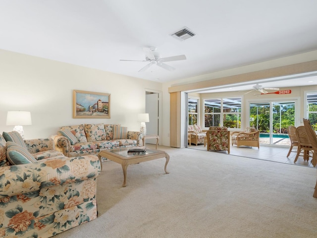 carpeted living room with ceiling fan