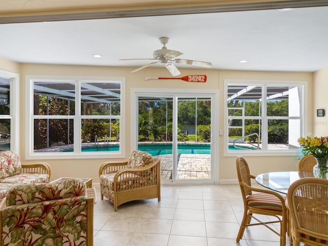 sunroom / solarium featuring ceiling fan