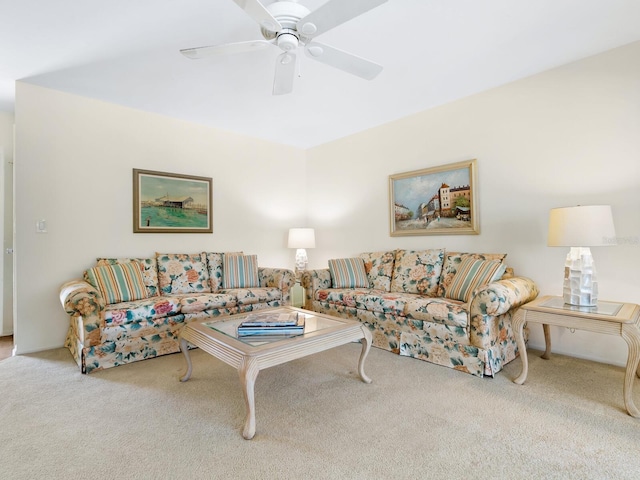 carpeted living room with ceiling fan