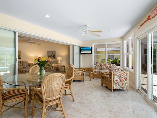 tiled dining space featuring a wealth of natural light and ceiling fan