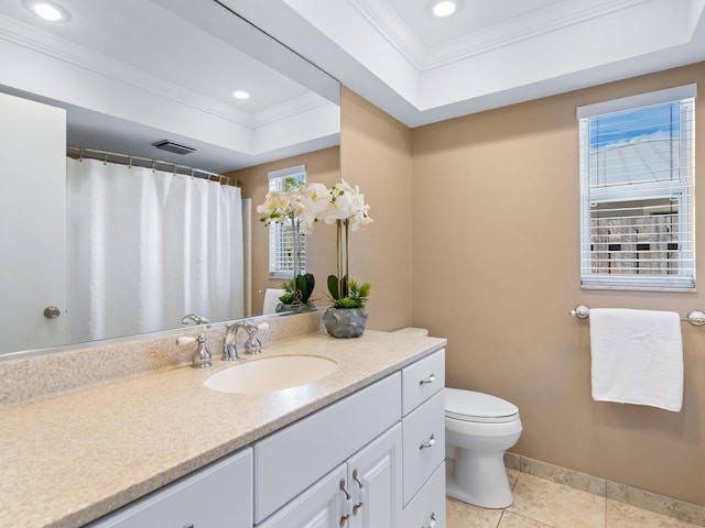 bathroom featuring vanity, tile patterned floors, toilet, ornamental molding, and a tray ceiling