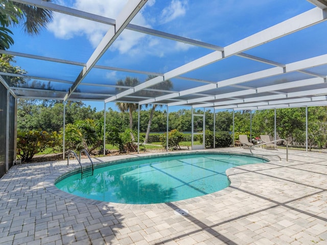 view of swimming pool with a lanai and a patio