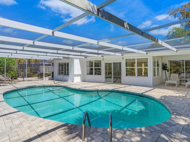 view of swimming pool with a lanai and a patio