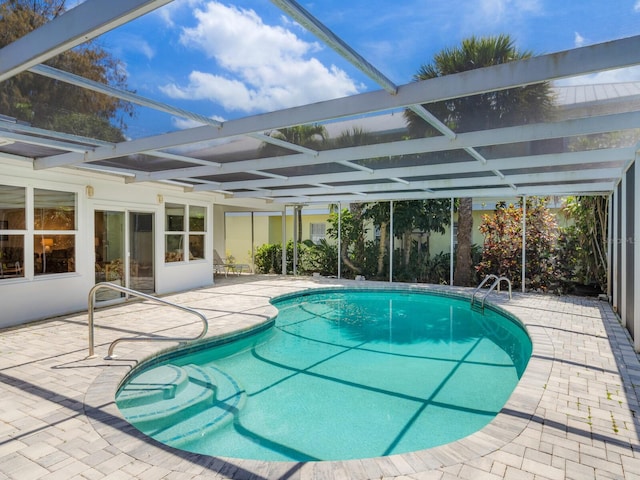 view of pool featuring a lanai and a patio