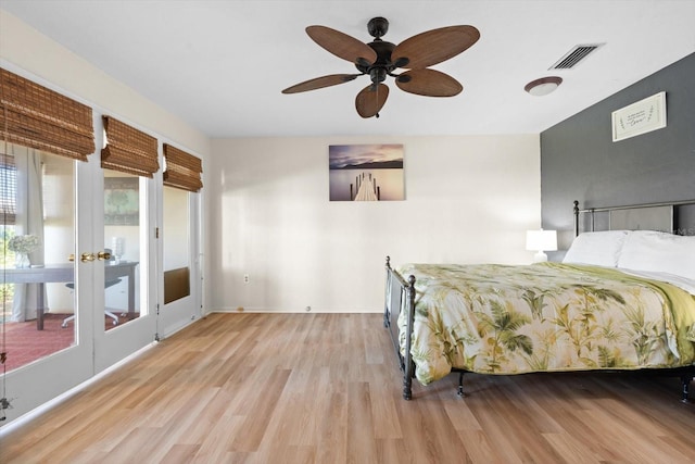 bedroom with light wood-type flooring, access to outside, and ceiling fan