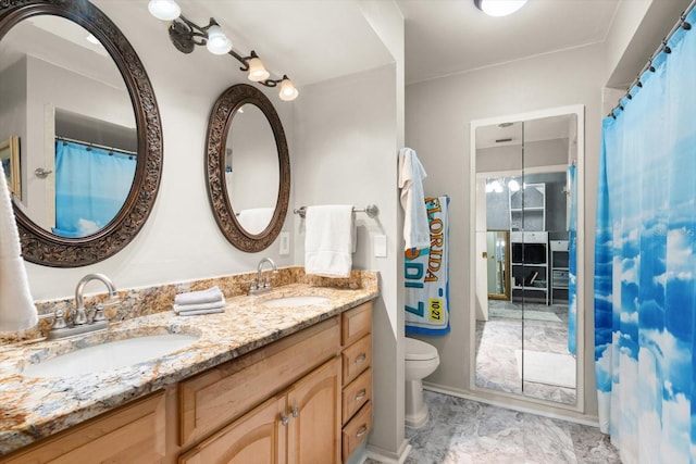 bathroom featuring vanity and toilet