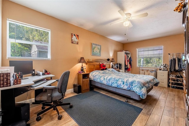 bedroom featuring hardwood / wood-style floors and ceiling fan