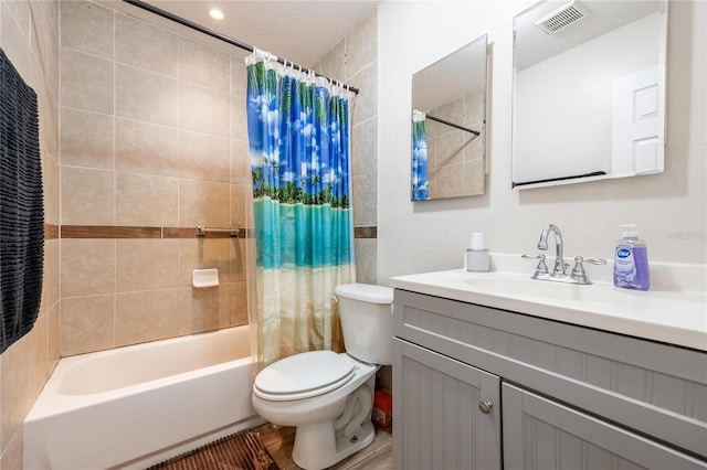 full bathroom with hardwood / wood-style floors, vanity, toilet, a textured ceiling, and shower / tub combo with curtain