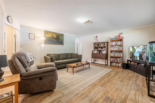 living room with light hardwood / wood-style flooring and ornamental molding