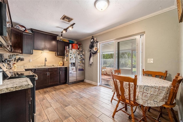 kitchen with black range with electric stovetop, sink, stainless steel refrigerator with ice dispenser, dark brown cabinets, and light wood-type flooring