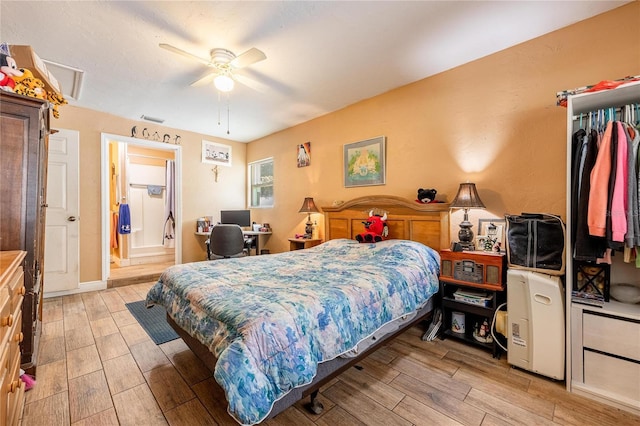 bedroom with light wood-type flooring, ensuite bathroom, and ceiling fan