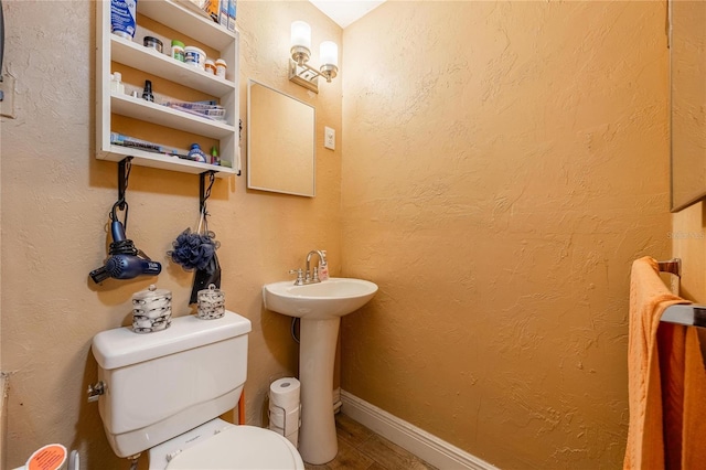 bathroom featuring toilet and sink