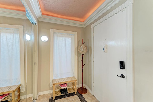 entryway with crown molding and a textured ceiling