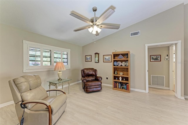 living area featuring ceiling fan, light hardwood / wood-style floors, and lofted ceiling