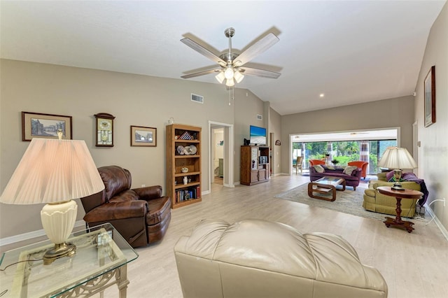 living room featuring ceiling fan, light wood-type flooring, and lofted ceiling