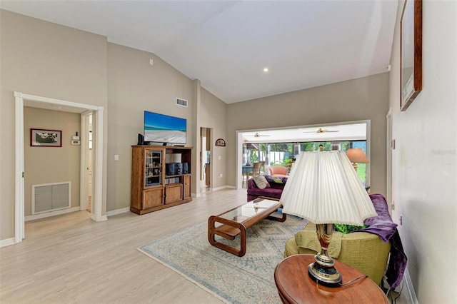 living room featuring light wood-type flooring, high vaulted ceiling, and ceiling fan